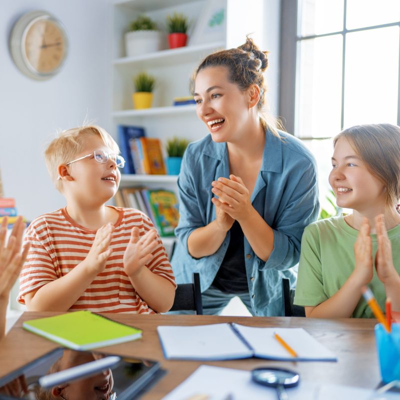 Happy kids and teacher at school